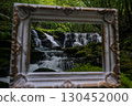 A waterfall leading to the Kikuchi Gorge with a clear stream flowing through nature 130452000