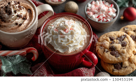 Festive hot cocoa with whipped cream and peppermint, surrounded by cookies and holiday decorations 130453194