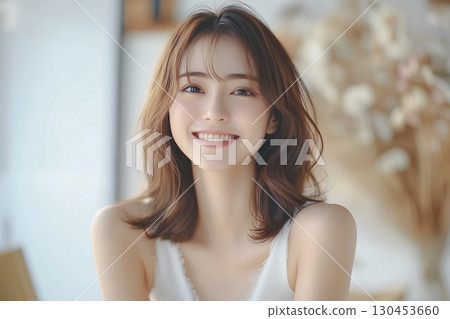 年輕女子的肖像,笑容甜美。背景是一間裝飾著乾燥花的房間。 年輕女子的肖像,笑容甜美。背景是一間裝飾著乾燥花的房間。 130453660