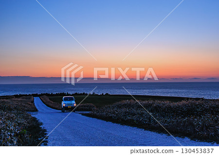 Jimny and the white road running through the Soya plains 130453837