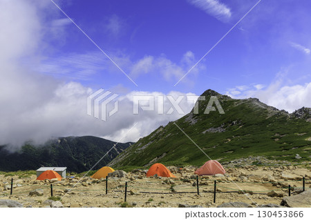 Summer scenery of the Kiso Komagatake tent site surrounded by blue skies and clouds Summer scenery of the Kiso Komagatake tent site surrounded by blue skies and clouds 130453866