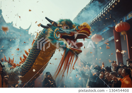 Green and gold dragon head with open mouth during a celebration in the street with blurred people in the background 130454408