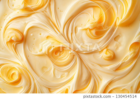 Smooth, creamy butter swirling together creating an abstract pattern, perfect for food related backgrounds 130454514