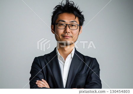 Portrait of a confident asian businessman wearing suit standing with arms crossed Portrait of a confident asian businessman wearing suit standing with arms crossed 130454803