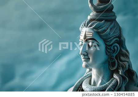 Serene statue of lord Shiva with eyes closed, emanating tranquility and spirituality on a blue background 130454885