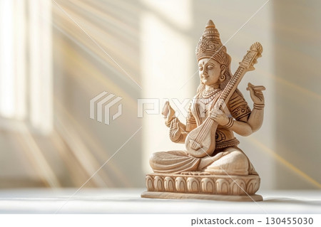 Wooden statue of goddess Saraswati playing a string instrument representing wisdom, art, and music in Hinduism Wooden statue of goddess Saraswati playing a string instrument representing wisdom, art, and music in Hinduism 130455030