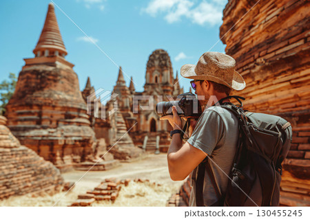 Photographer is capturing the beauty of ancient asian temple ruins, immersing himself in the rich history and culture 130455245