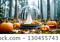Ghost figure in a Halloween snow globe placed in a spooky autumn forest with pumpkins. 130455743