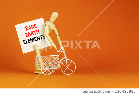 Rare earth elements symbol. Concept words Rare earth elements on beautiful white paper on wooden clothespin. Beautiful orange background. Business and rare earth elements concept. Copy space. 130455983