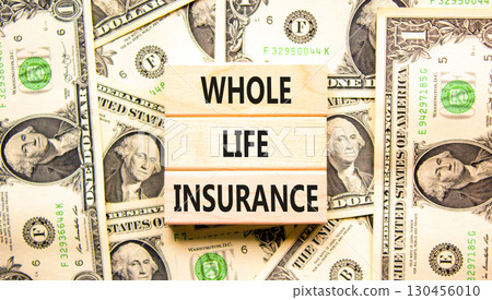 Whole life insurance symbol. Concept words Whole life insurance on beautiful wooden blocks. Dollar bills. Beautiful background from dollar bills. Business whole life insurance concept. Copy space. 130456010