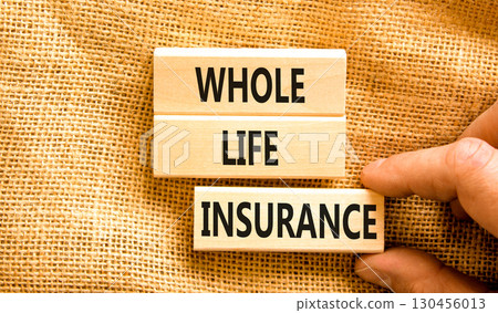 Whole life insurance symbol. Concept words Whole life insurance on beautiful wooden blocks. Beautiful canvas background. Businessman hand. Business whole life insurance concept. Copy space. 130456013
