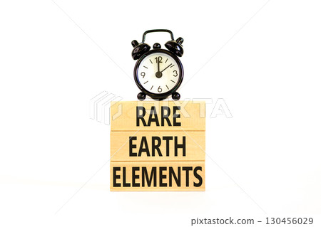 Rare earth elements symbol. Concept words Rare earth elements on beautiful wooden block. Black alarm clock. Beautiful white background. Business and rare earth elements concept. Copy space. 130456029