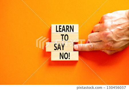 Learn to say no symbol. Concept words phrase Learn to say no on beautiful wooden blocks. Beautiful orange paper background. Businessman's hand Business psychological Learn to say no concept Copy space 130456037