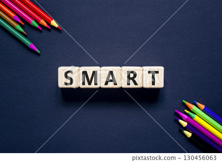 Smart symbol. Concept word Smart on beautiful wooden blocks. Beautiful black table black background. Beautiful colored pencils. Business lifestyle smart concept. Copy space. Smart symbol. Concept word Smart on beautiful wooden blocks. Beautiful black table black background. Beautiful colored pencils. Business lifestyle smart concept. Copy space. 130456063