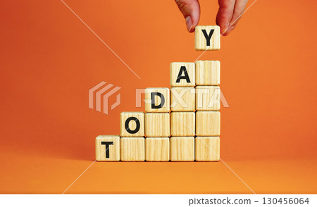 Today symbol. Concept word Today on beautiful wooden blocks. Beautiful orange table orange background. Businessman hand. Business lifestyle today concept. Copy space. 130456064