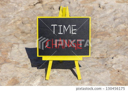 Time change symbol. Concept word Time change on beautiful black blackboard. Beautiful stone background. Black blackboard. Business time change concept. Copy space. Time change symbol. Concept word Time change on beautiful black blackboard. Beautiful stone background. Black blackboard. Business time change concept. Copy space. 130456175