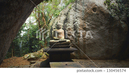 Serene Buddha Statue Surrounded by Nature's Embrace Serene Buddha Statue Surrounded by Nature's Embrace 130456574