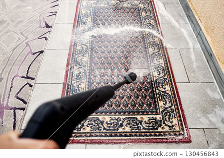 Top-Down View of Pressure Washing a Rug 130456843