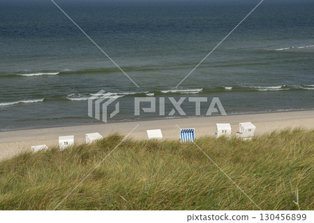 Sylt Island Sunbeds Strandkorbe Outsun on the sandy beach Sylt Island Sunbeds Strandkorbe Outsun on the sandy beach 130456899