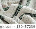 Knitted beige sweater with spike-shaped pattern and green line 130457239