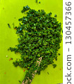 Chopped green parsley herbs on cutting board ready for cooking use and garnish 130457366