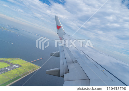 Wing of an airplane taking off 130458798