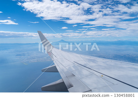 Wing of an airplane flying overhead Wing of an airplane flying overhead 130458801