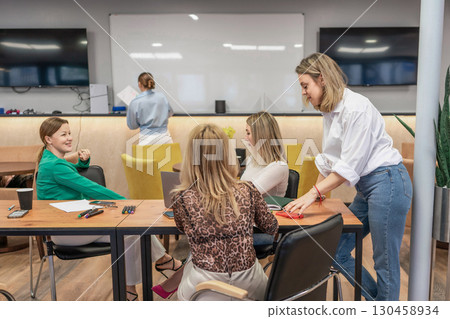 Office Teamwork Whiteboard: Women collaborate during daytime meeting, brainstorm ideas for business growth. Office Teamwork Whiteboard: Women collaborate during daytime meeting, brainstorm ideas for business growth. 130458934