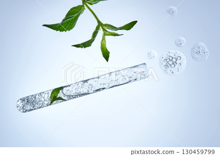 A test tube with the texture of serum or other cosmetics with mint and herbs. A test tube with the texture of serum or other cosmetics with mint and herbs. 130459799