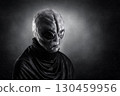Mysterious humanoid alien at night over dark misty background 130459956