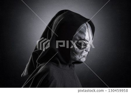 Mysterious humanoid alien at night over dark misty background 130459958