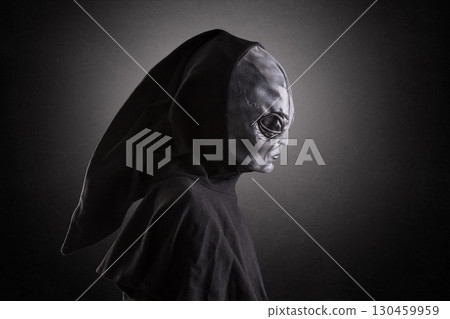 Mysterious humanoid alien at night over dark misty background 130459959