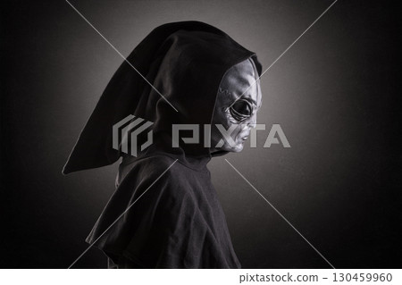Mysterious humanoid alien at night over dark misty background 130459960