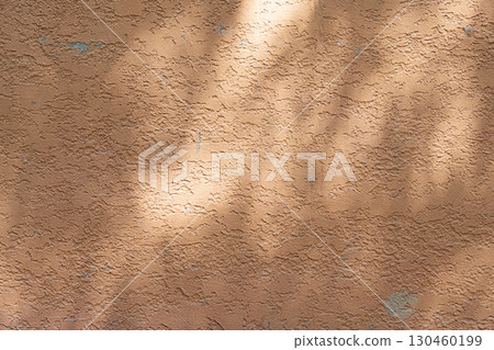Wall with texture and shadows. Orange, brown concrete background Wall with texture and shadows. Orange, brown concrete background 130460199