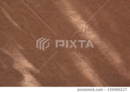 Wall with texture and shadows. Orange, brown concrete background 130460227