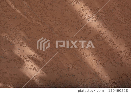 Wall with texture and shadows. Orange, brown concrete background Wall with texture and shadows. Orange, brown concrete background 130460228