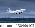 Modern white passenger plane takes off runway in cloudy weather 130460403