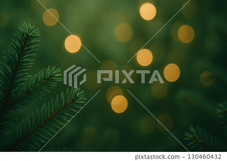Close up of fir tree needles with dreamy golden bokeh lights creating soft green forest ambiance, evoking magical holiday atmosphere 130460432