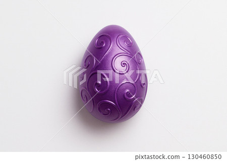Metallic purple Easter egg with ornate swirls on white background, perfect for seasonal decoration and minimalist holiday themes 130460850