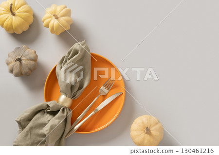 Autumn composition of colorful small pumpkins, empty plate with cutlery. Autumn composition of colorful small pumpkins, empty plate with cutlery. 130461216