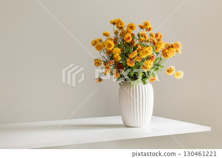 Yellow Flowers in Elegant White Vase Display 130461221