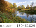 A bridge over a body of water surrounded by trees 130461829