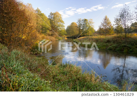 A bridge over a body of water surrounded by trees 130461829