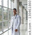 Latin American male doctor in white coat standing in modern hospital, confident expression, natural lighting, stethoscope, medical environment, healthcare realism AI generated 130461860