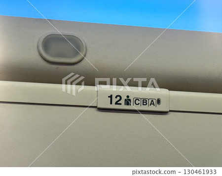 Overhead luggage compartments and cabin ceiling inside a passenger airplane. Travel, aviation, and the practical design of space in modern aircraft cabins. 130461933
