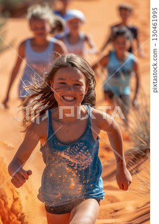 A joyful girl running through sandy dunes, embodying the spirit of adventure and childhood joy with friends. A joyful girl running through sandy dunes, embodying the spirit of adventure and childhood joy with friends. 130461995