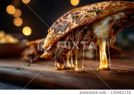 Indulgent bite into a cheesy birria taco at a cozy street food market 130462116