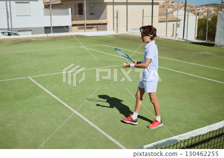 Young Tennis Player on Grass Court During Practice Session 130462255