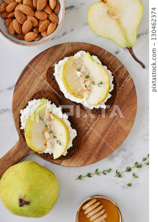 Bruschetta with cream cheese, honey, pear, thyme 130462374