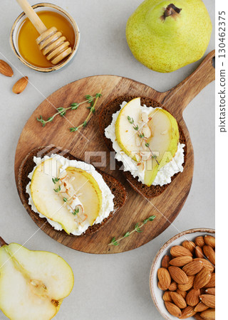 Bruschetta with cream cheese, honey, pear, thyme 130462375